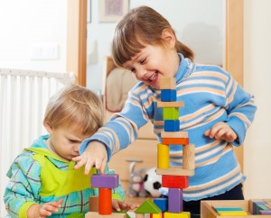 siblings together playing with toys